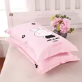 Pair of pink pillowcases with cute bunny cartoon design and Love Happy text print on bed - Bunny Pattern