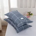 Close-up of a pair of modern blue checkered pillowcases with love simple print - Mustache Grid