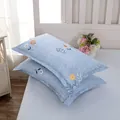 Detail of blue cotton-feel pillowcases with elegant floral pattern for home decor - Colorful