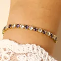Close-up of elegant gold tennis bracelet with purple and clear stones on wrist - 14k Gold White & Purple Zirconia (3858)