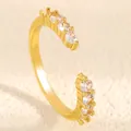 Macro detail view of gold-plated open ring with rows of clear sparkling round zirconia. - Row Zirconia Open Style (K-104) / Medium KC Gold (K-104)