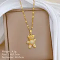 Macro detail of a gold-plated bear pendant necklace with sparkling micro-pave crystals. - Gold Teddy Bear Style (D205)