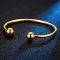Minimalist gold plated stainless steel open cuff bangle with spherical ball ends - Bead Bracelet / Gold