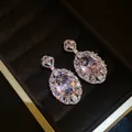 Elegant pink oval cubic zirconia drop earrings presented in a luxury dark velvet jewelry box - Earrings / Pink
