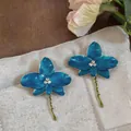 Elegant blue orchid enamel earrings with sparkling rhinestones and green stem detail - Light Blue