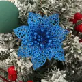 Close-up of blue hollow glitter poinsettia flower on snowy Christmas tree branch - Royal Blue