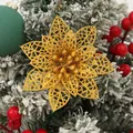 Primer plano de una flor de nochebuena decorativa hueca con purpurina dorada en un pino. - Dorado