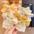Assorted set of yellow children's bow hair ties with floral and gingham patterns. - Yellow Floral Style (0662-13)
