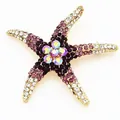 Exquisite close-up of a sparkling starfish brooch with purple and clear rhinestones - Purple Rhinestone Starfish