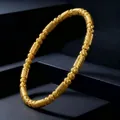 Elegante bracciale rigido in acciaio inossidabile dorato con texture a coste da donna - Oro