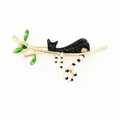 Enamel black cat resting on golden branch brooch with green leaves and white stripes - Black Cat on Branch Style