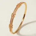 Elegant gold-tone bangle with sparkling pavé zircon and cross-knot decorative details. - Stylish And Versatile Light Luxury Bracelet Bs-j5575g