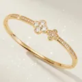 Elegant gold floral bangle bracelet meticulously inlaid with sparkling cubic zirconia stones - Gold Floral Bangle BS-J5581G