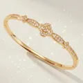 Elegant gold-plated copper flower bangle inlaid with shimmering cubic zircon crystals. - Gold Exotic Style Bangle BS-J5634G