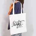 Minimalist white canvas tote bag for women featuring a decorative Be the Light print - Be The Light Matthew 5:14 Style (23)