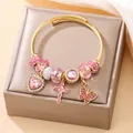 Elegant gold stainless steel charm bracelet featuring pink heart and butterfly pendants - Pink