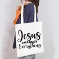 White canvas tote bag with Jesus Changes Everything print shown on model shoulder - Jesus Changes Everything Style (9)