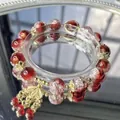 Close-up of red and white crackle glass beaded bracelet with gold flower charms. - Red and White Ice Crack Flower Base Style (S433)