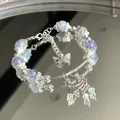 Elegant light blue beaded bracelet with silver butterfly and traditional lock charms - Blue and Purple Lock Tassel Style (S437)