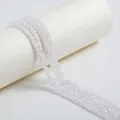 Macro detail of high-quality sparkling white faceted zircon beads for jewelry making - 4mm / White