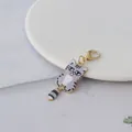 Detailed view of a cute grey tabby cat charm with a grumpy expression and gold clasp. - Gray