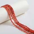 Close-up detail of small red faceted zircon beads for DIY jewelry making accessories - 4mm / Dark Orange