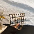 Elegant black and white plaid pattern crossbody bag with a stylish gold chain strap - White Lattice