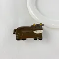 Close-up of a brown cartoon cow hair claw clip made of smooth acetate material - Cow