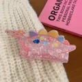 Pink dinosaur acrylic hair claw clip with colorful spikes on knit background - Pink Dinosaur