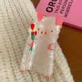 Cute pig-shaped acrylic hair claw clip with pearlized texture holding red tulips - Pink Pig with Bouquet
