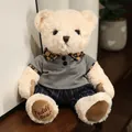 Simpatico orsetto di peluche color crema con camicia grigia e pantaloni a righe su scaffale - Orsetto Bianco in Abiti Grigi / 20-30cm