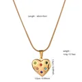 Macro view of heart-shaped gold pendant with inlaid stones and measurement details - Xl529