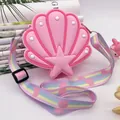 Detailed view of pink shell-shaped silicone crossbody bag with rainbow heart strap - Pink Shell