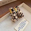 Vintage leopard print geometric leather earrings displayed in a luxury wooden jewelry box - Geometric U-Shape Clasp Style / Brown