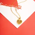 Elegant gold-tone heart pendant necklace with textured radiating pattern - X2355 Heart Necklace