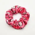 Macro view of silky pink satin hair scrunchie with baseball sports ball print pattern - Pink Base Football