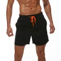 Men's black quick-dry swim trunks featuring an orange drawstring and elastic waistband - L / Black