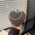 Elegant sparkling black heart-shaped evening clutch bag featuring a gold chain strap - Black