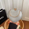 Elegant silver heart-shaped evening clutch with glitter finish and gold chain strap. - Silver