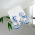 Close-up of elegant blue and white ceramic round drop earrings with 925 silver posts. - Double Ring Layered (1604-02)