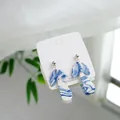 Close-up detail of blue and white ceramic dangle earrings featuring 925 silver posts - Long Blue And White (1604-03)