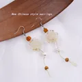 Elegant New Chinese style earrings featuring white rose charms, wooden beads, and tassels - 1140-02 White Flower