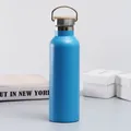 Blue stainless steel vacuum insulated sports water bottle with a bamboo handle lid - Blue