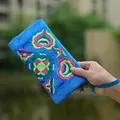 Vibrant blue Yunnan ethnic embroidered canvas clutch purse with colorful floral patterns - Sky Blue