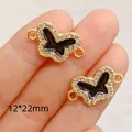 Detailed view of gold-plated butterfly charms with black enamel and rhinestones, 12x22mm size - Hollow Butterfly Shape (6100289847352)