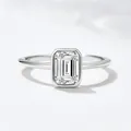 Close-up of elegant S925 silver ring with an emerald-cut zircon in a bezel setting - US 5 / White