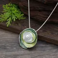 Close-up detail of a green enamel rose pendant necklace with a white center pearl - Emerald Green Gradient Rose Artificial Pearl Pendant - Gold