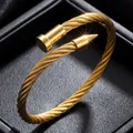 Elegant gold-plated stainless steel twisted cable nail bracelet shown in a black box - 42-b-2 Gold Wire Nail Bracelet