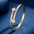Elegant gold titanium steel bracelet with clover charms and full diamond inlay - Gold