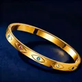 18K gold plated stainless steel evil eye bangle featuring colorful crystal accents - Gold